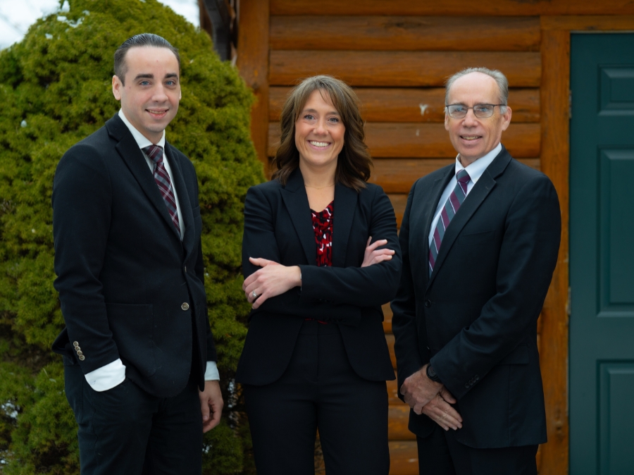 Corbin Curley,
Founder, Managing Director, Jody Angellotti
Senior Financial Consultant, and Edward Curley, the other
Founder, Managing Director of Curley Wealth Management all pose outside their offices in Oneonta, NY