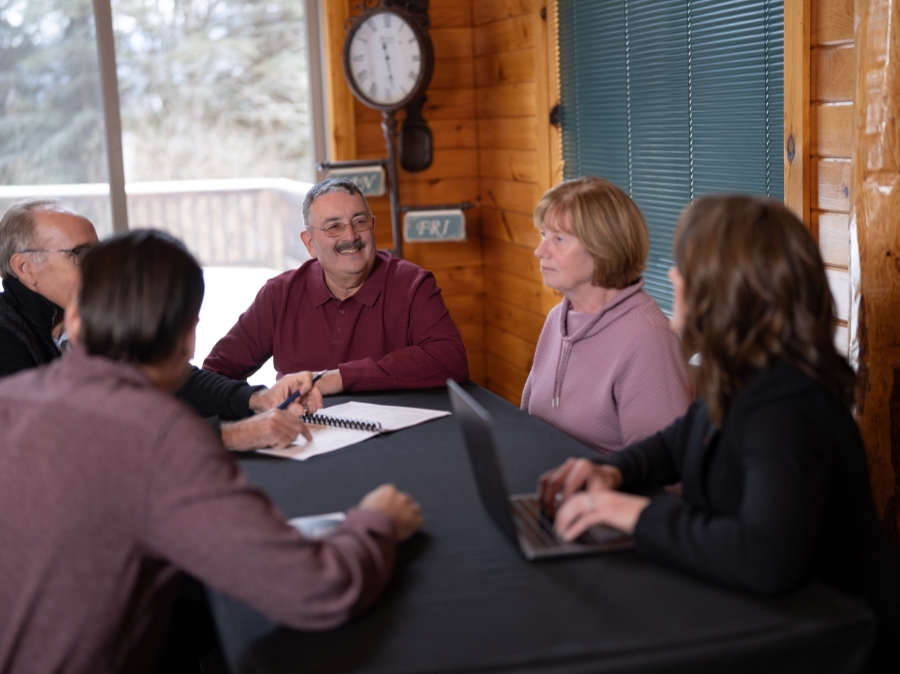 The Curley Wealth Advisor team meets with clients in their offices in upstate New York